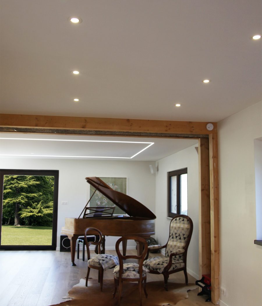 Plafond acoustique blanc dans un salon avec un éclairage périphérique Photo d'un plafond acoustique blanc dans un salon avec un éclairage périphérique